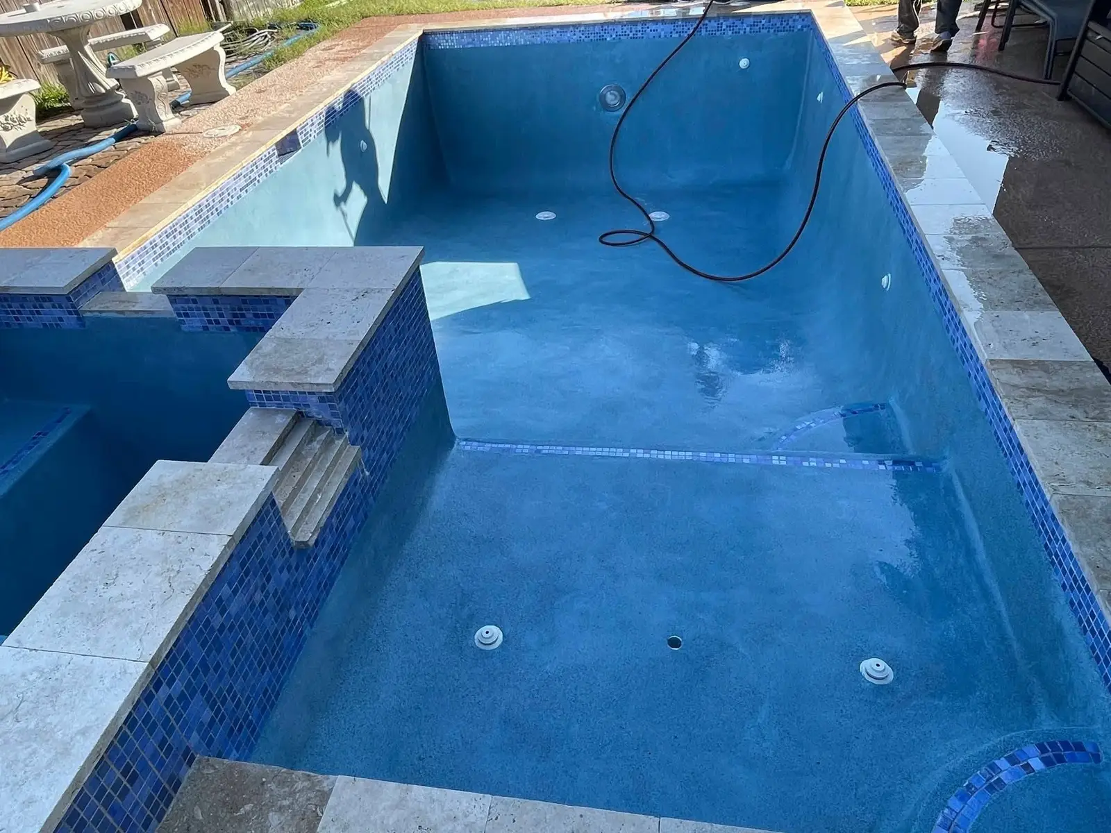 Same pool with fresh blue plaster applied, drained